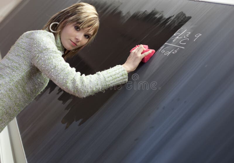 Student erasing the chalkboard/blackboard