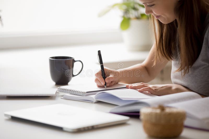 Student girl writing essay preparing for university entrance exams royalty free stock image Student girl writing essay preparing for university entrance exams royalty free stock image