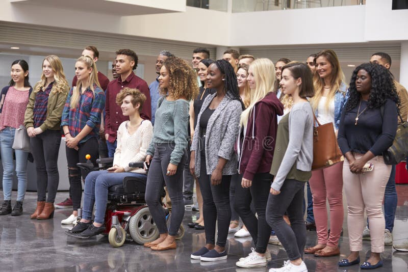 Student group standing in university atrium looking away stock photography Student group standing in university atrium looking away stock photography