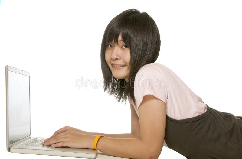 Student laying down and using computer