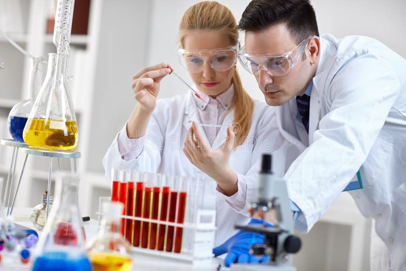 Student looking at a microscope slide in a laboratory