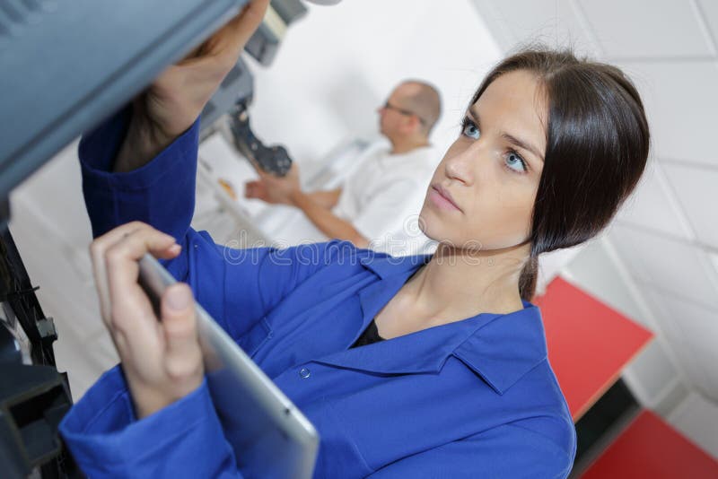 Student mechanic using tablet pc stock photos Student mechanic using tablet pc stock photos