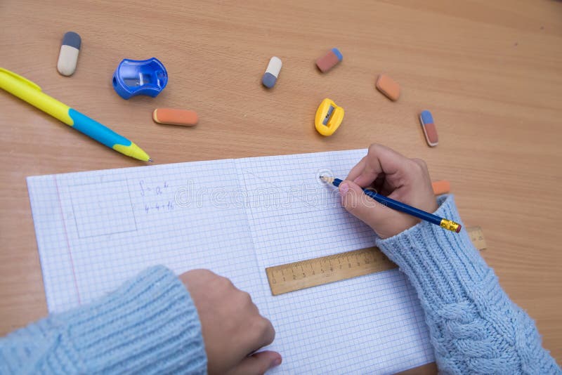 The student in the notebook signs the notation with a pencil. royalty free stock image
