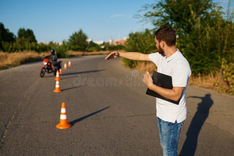 Student rides around the cones, motorcycle school stock photography