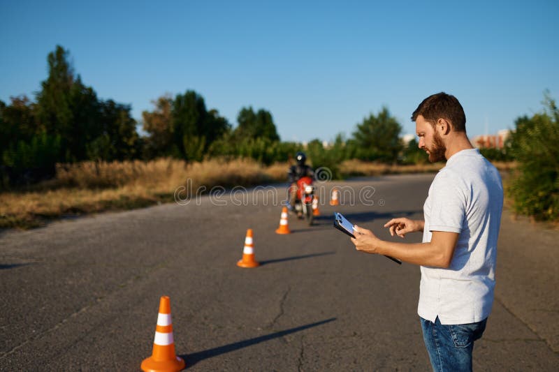Student rides around the cones, motorcycle school stock photo