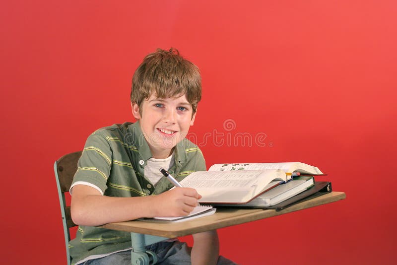 Student smiling at desk