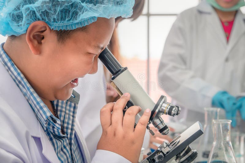 Student using microscope in biology laboratory stock image