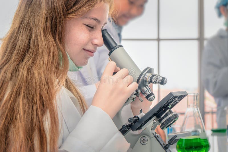 Student using microscope in biology laboratory royalty free stock photo