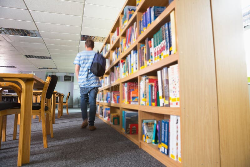 Student walking away in the library royalty free stock images Student walking away in the library royalty free stock images