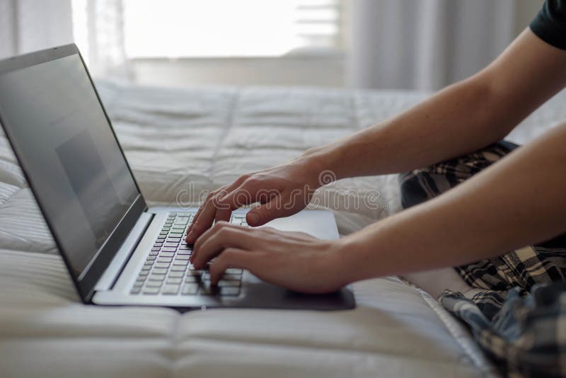 Student Working on Laptop Computer on Bed in Morning Light Stock Image Image of wireless