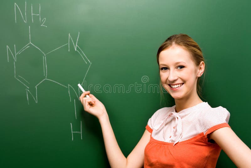 Student writing chemical symbols royalty free stock photography