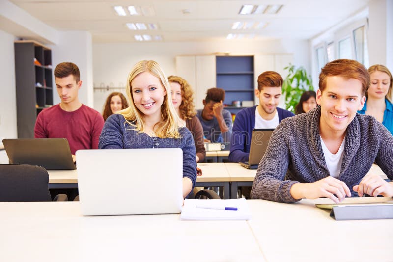 Students learning with computers in a university class. Students learning with computers in a university class