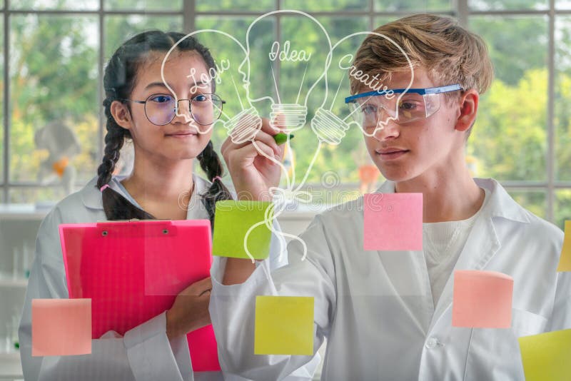 Studenti adolescenti che disegnano immagine delle idee su un bordo di vetro fotografia stock libera da diritti Studenti adolescenti che disegnano immagine delle idee su un bordo di vetro fotografia stock libera da diritti