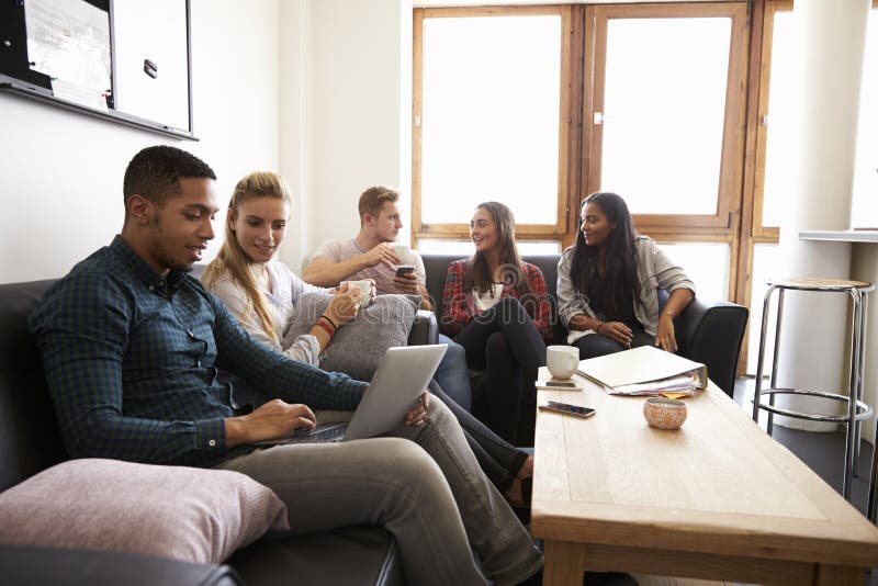 Students Relaxing In Lounge Of Shared Accommodation. Students Relaxing In Lounge Of Shared Accommodation