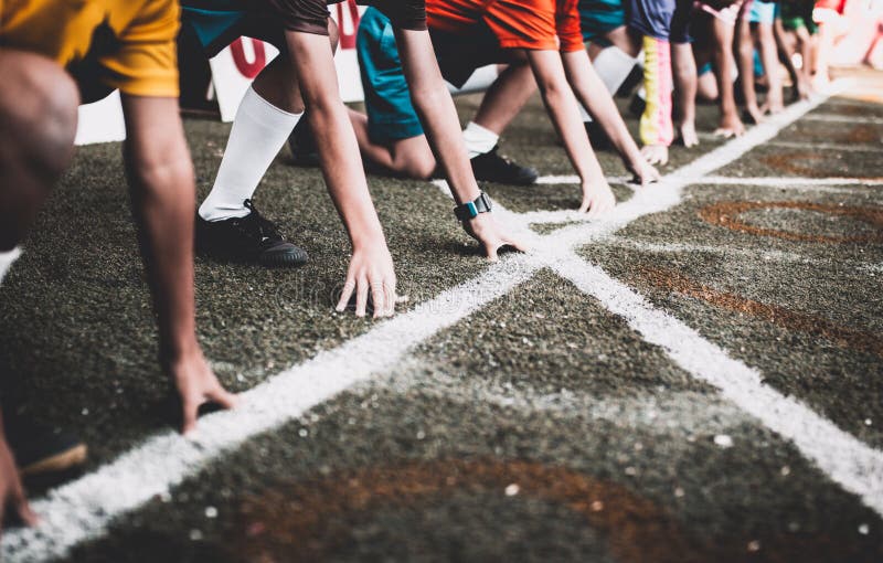 Students boy get set to leaving the starting for running competition boy at school sports day.