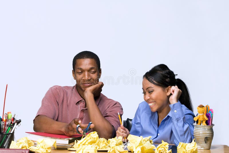 Students at Desk with Crumpled Paper - Horizontal