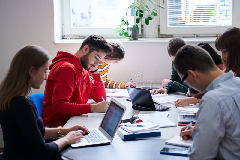 Students Group Working on School Project Together on Tablet Computer at Modern University Stock