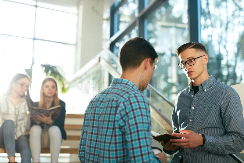 Students Learning, Reading Book In College stock photo