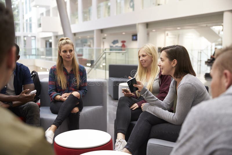 Students meeting in the foyer of modern university building royalty free stock photography