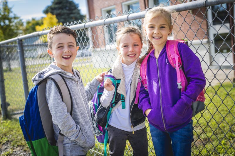 Students outside school standing together stock photo Students outside school standing together stock photo