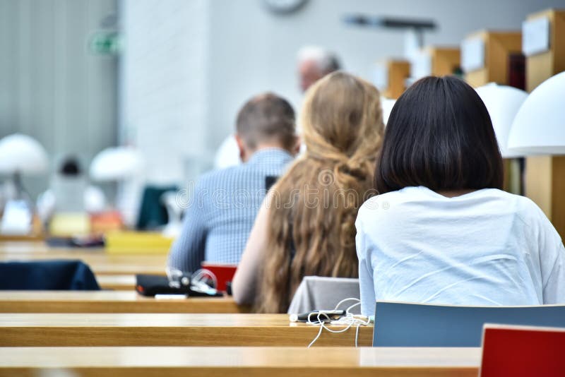 Students reading in a public library royalty free stock photography