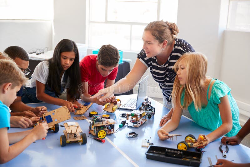 Students In After School Computer Coding Class Building And Learning To Program Robot Vehicle stock photography