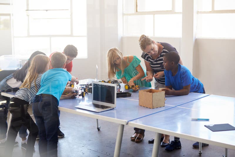 Students In After School Computer Coding Class Building And Learning To Program Robot Vehicle stock photos