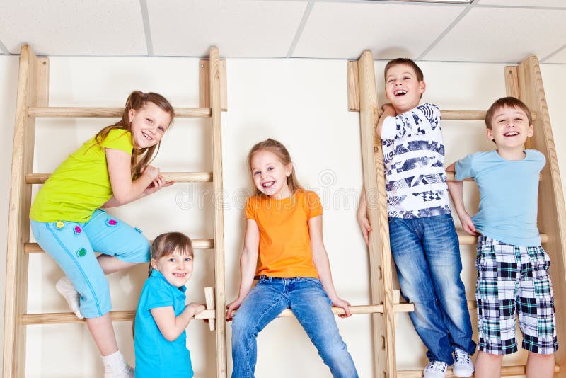 Students sitting on wall bars royalty free stock photography