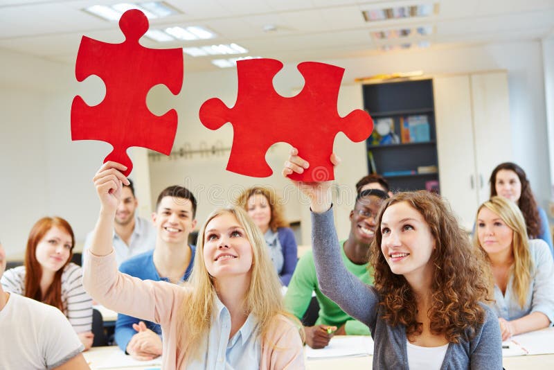 Students solving jigsaw puzzle as a team stock images