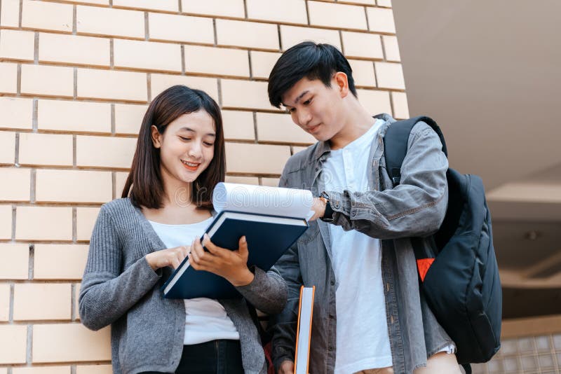 Students Stand To Read a Book Together on the Campus. Education Concept ...