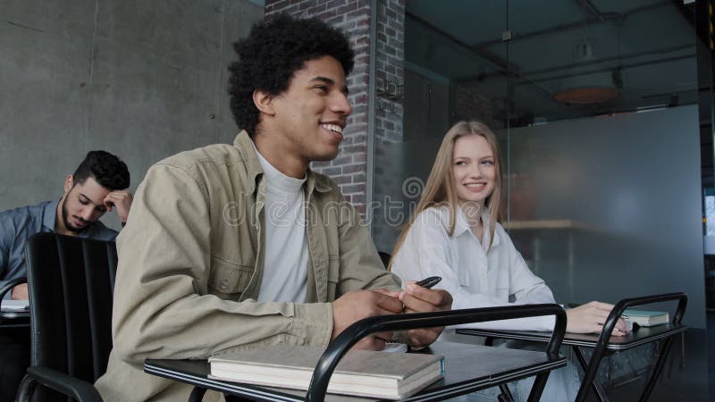 Students study in classroom group young happy people sitting at desk at lesson listening to lecture learning new topic stock video