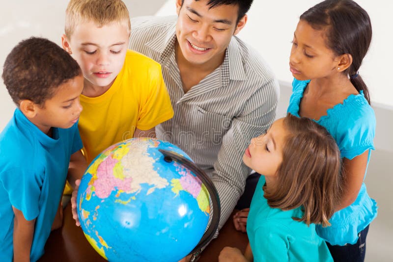 Group of adorable students with teacher looking at the globe. Group of adorable students with teacher looking at the globe