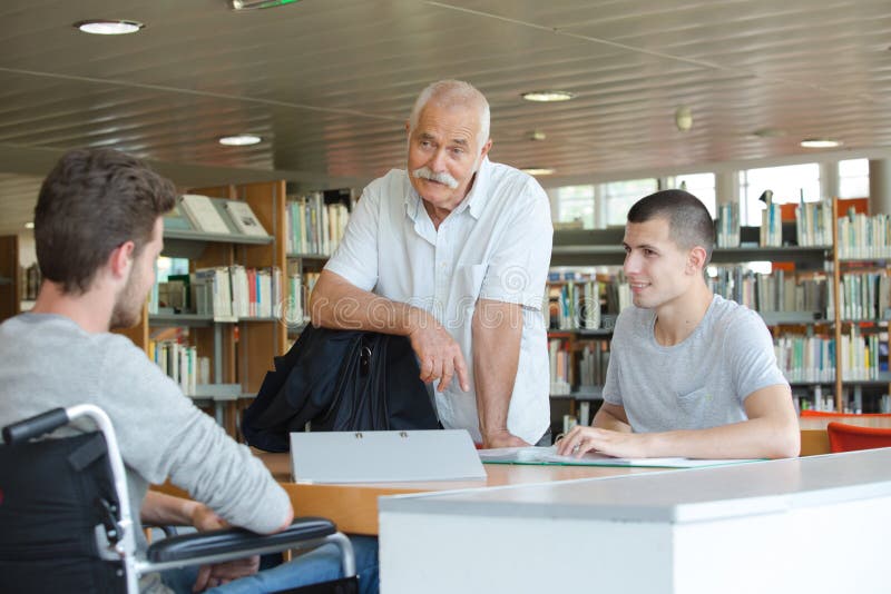 Students and teacher in library royalty free stock image