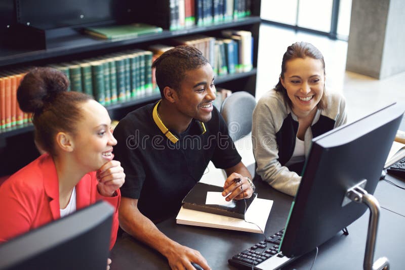 Students working on computer in a college library stock image Students working on computer in a college library stock image