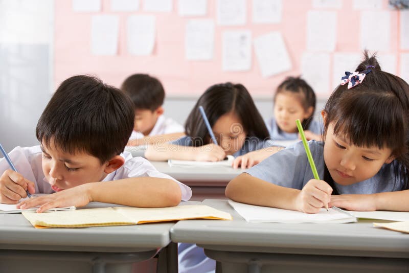 Students Working At Desks In Chinese School royalty free stock photography