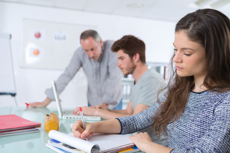 Students writing something during class stock photography