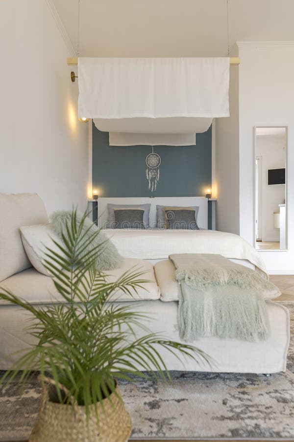 Studio Apartment with One Double Bed and One Single Bed. There is Also Parquet Flooring, a Lamp