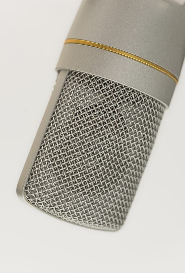 Studio Condenser Microphone CloseUp with Metal Mesh and Gold Accent Capent on Clean White Background royaltyfria foton