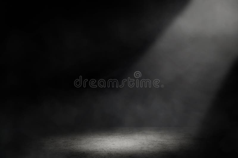 Studio dark room with spot lighting and fog in black background.