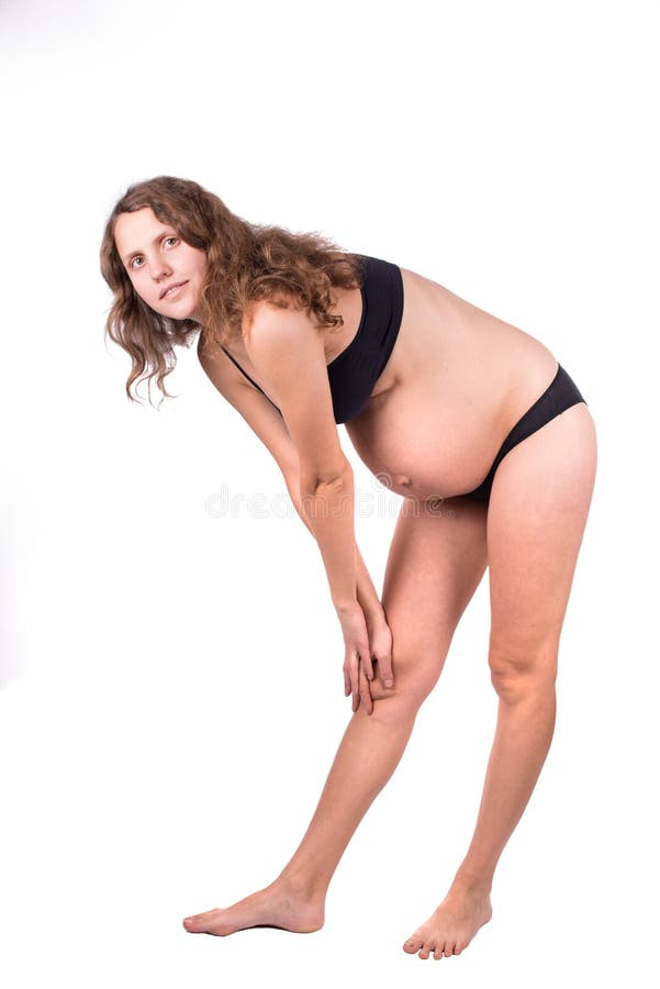 Studio isolato allungamento caucasico incinto della donna fotografia stock libera da diritti Studio isolato allungamento caucasico incinto della donna fotografia stock libera da diritti