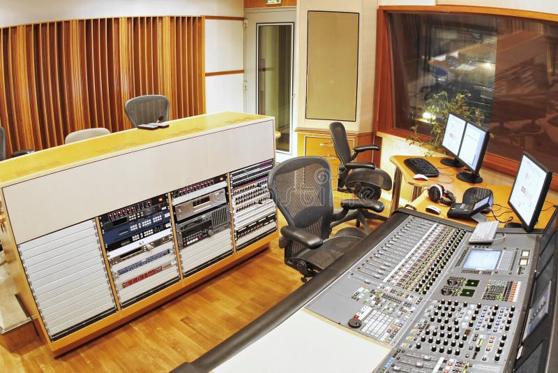 A shot of a recording studio, complete with technition and equipment. A shot of a recording studio, complete with technition and equipment.