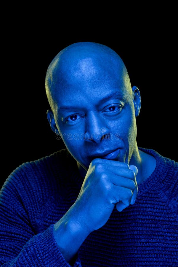 Studio Photo with Blue Light of a Black Man Looking at the Camera with