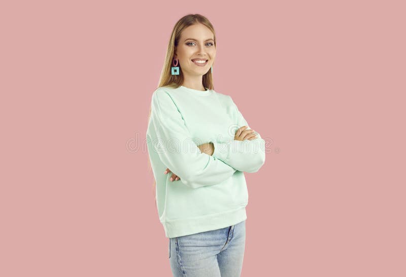 Cute teen girl smiling. Studio portrait of a teenage girl in jeans