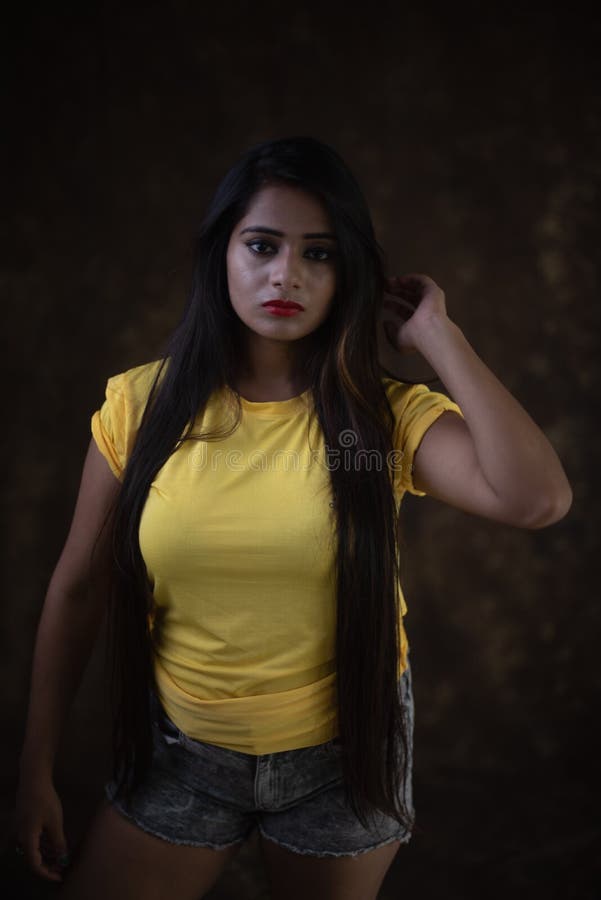 Studio Portrait of a Beautiful and Young Indian Bengali Female Model in  Yellow Tee Shirt and Jeans Hot Pat Stock Photo - Image of fashion, black:  205722146