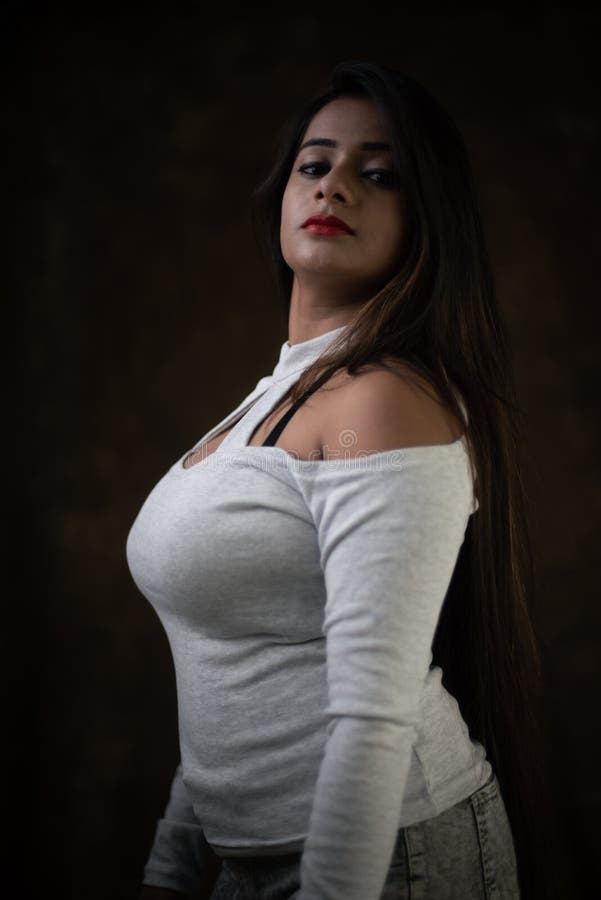 studio-portrait-beautiful-young-indian-bengali-female-model-white-cold-shoulder-top-jeans-hot-pant-studio-portrait-205745770