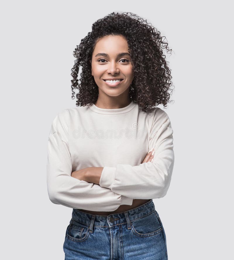 Studio portrait of a beautiful young woman with black curly hair. African american student girl close up isolated on white backgro