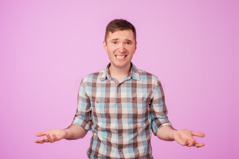 Studio portrait of confused handsome guy showing I have no idea gesture. royalty free stock photography Studio portrait of confused handsome guy showing I have no idea gesture. royalty free stock photography