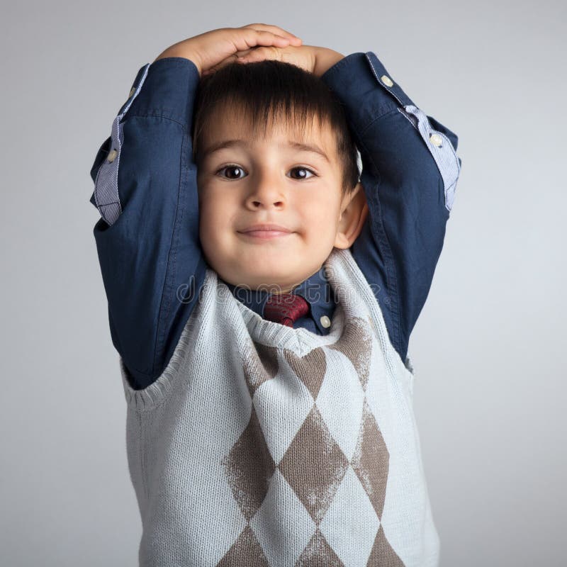 Studio portrait of a cute little boy, a child threw his hands behind his head stock images Studio portrait of a cute little boy, a child threw his hands behind his head stock images