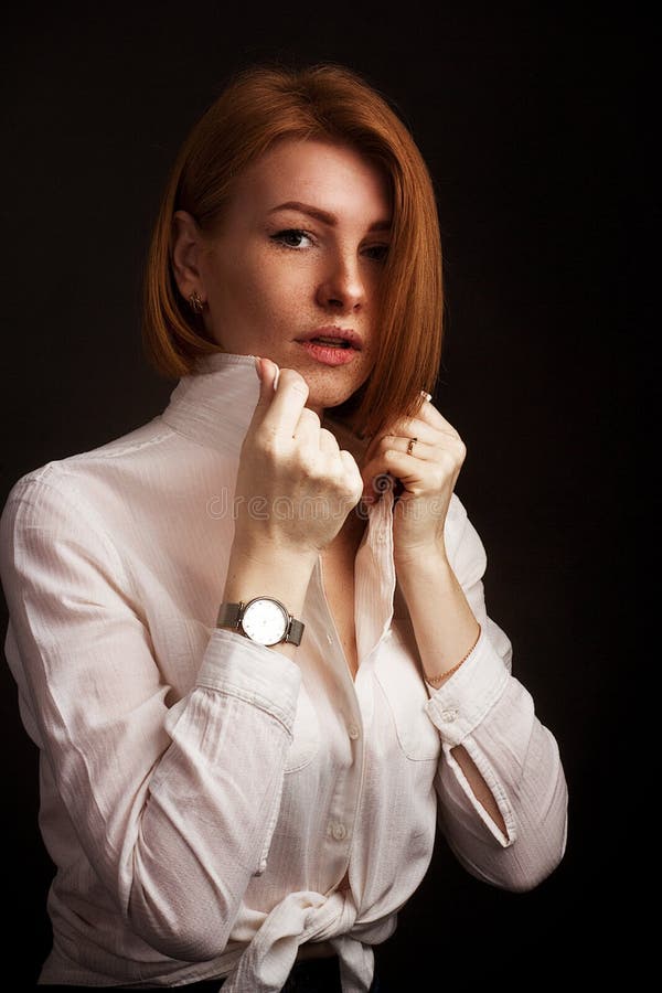 Studio Portrait of a Ginger Girl with Freckles on a Black Background ...