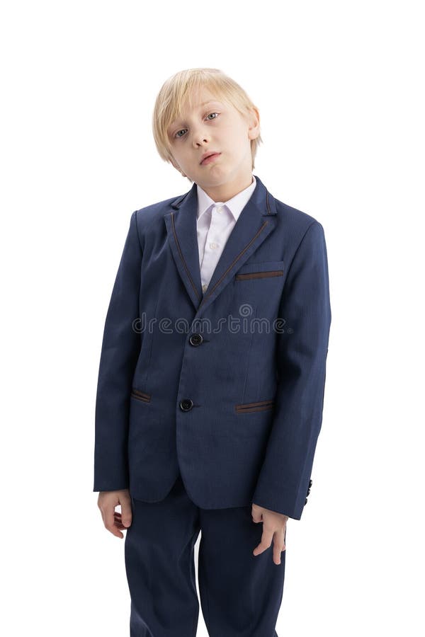 Studio portrait of male elementary student in white background. Blond schoolboy in school uniform. Vertical frame royalty free stock photography
